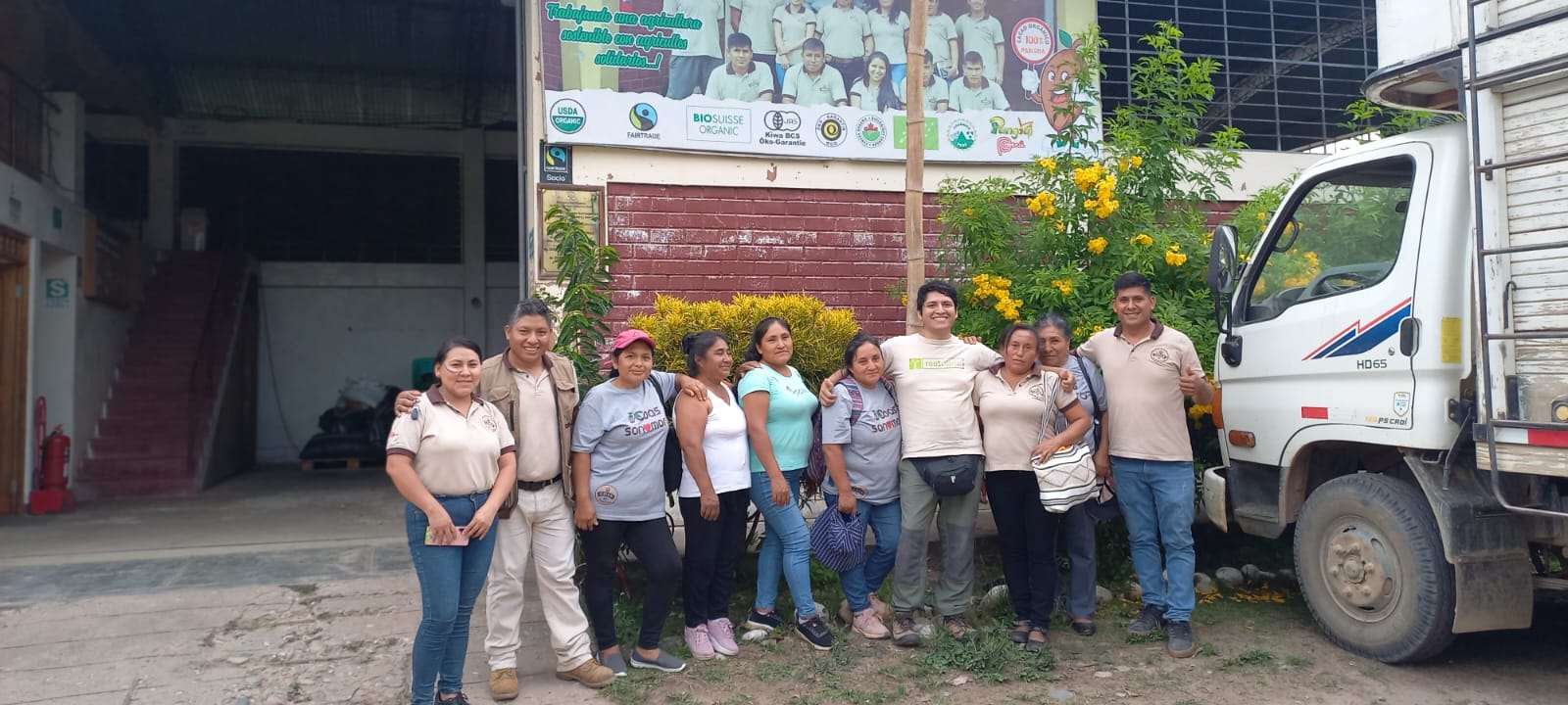 Root Capital's Junior Loan Officer Brayam Quilca Román with cooperative members at the COAS cacao cooperative in Pangoa, Peru. Credit: Root Capital