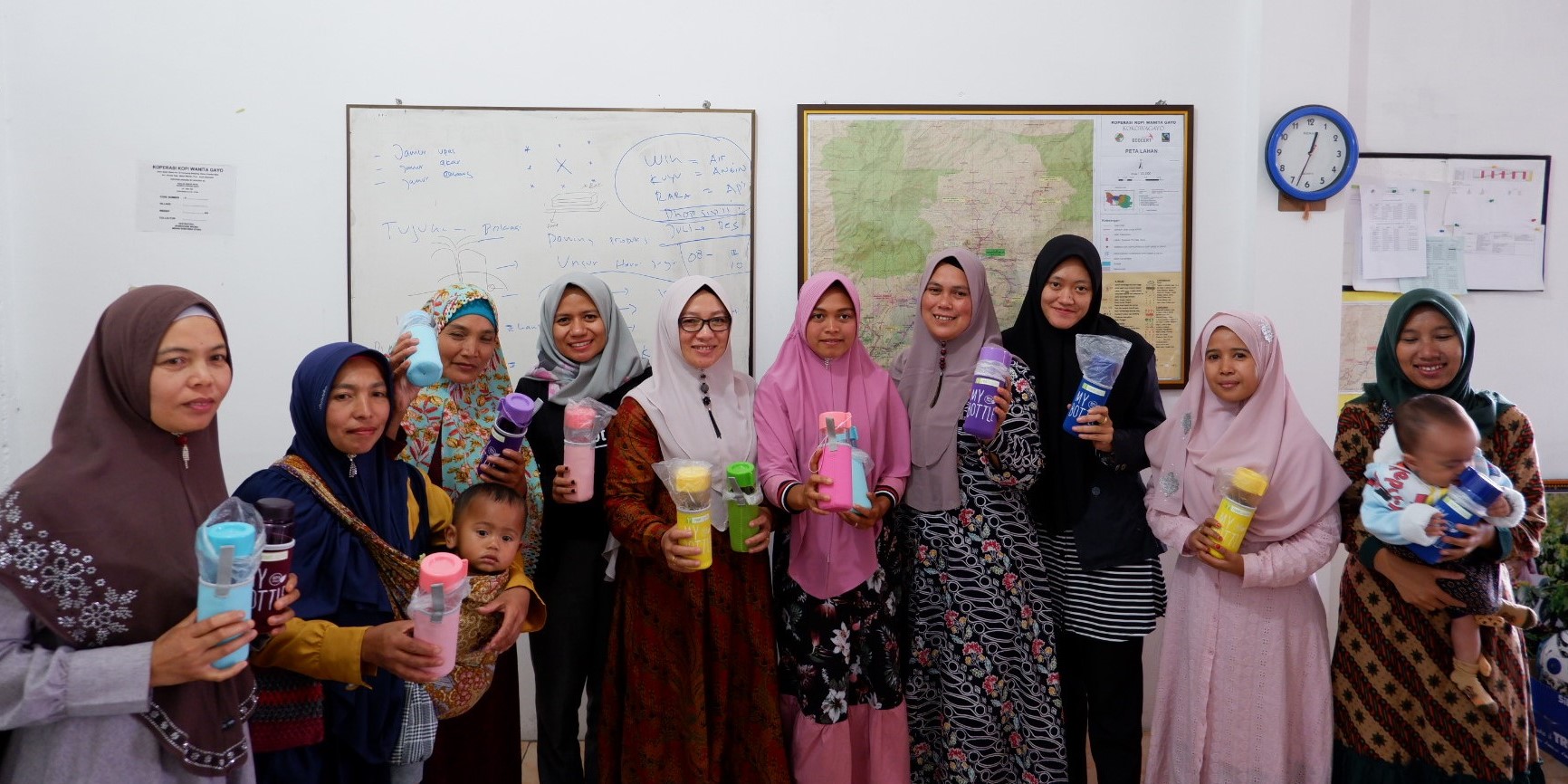 Women cooperative members pose for a photo taken during a 2019 incremental income study on coffee clients in Indonesia. Credit: Root Capital.
