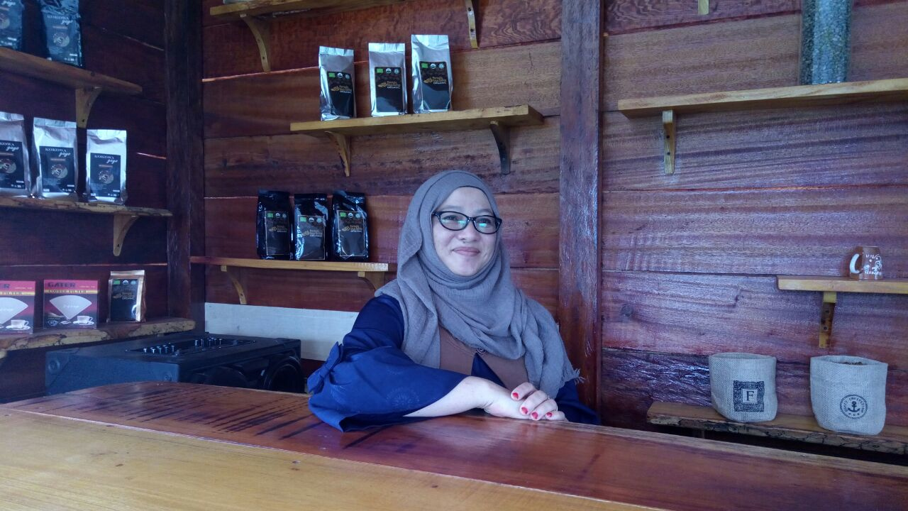 Ibu Rizkani, Founder and Position Chair of the first women-only cooperative Kokowagayo in Aceh, Indonesia, pictured in their storefront. Credit: Root Capital.