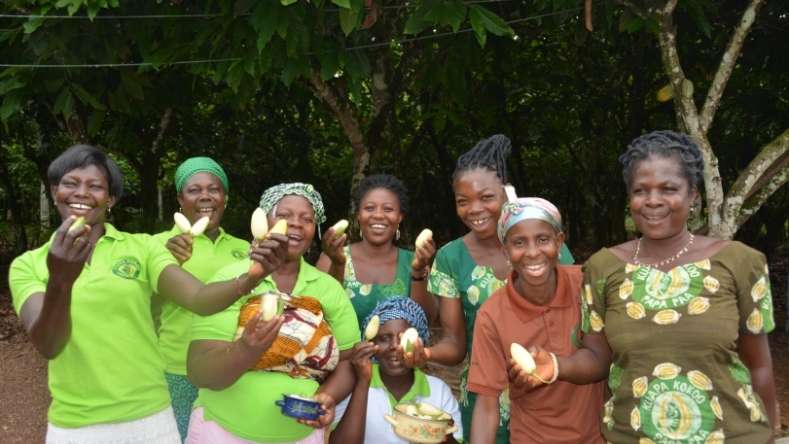 Members of Margret's women’s group showing off their crop of aubergines from the communal farm.