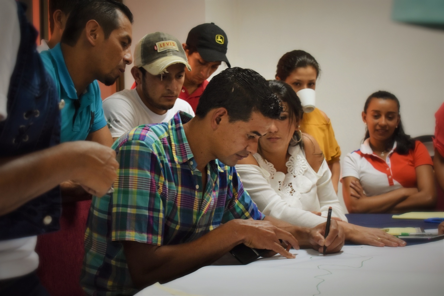 Young producer-members of El Gorrión sketch the map of their proposed ecotourism trail.
