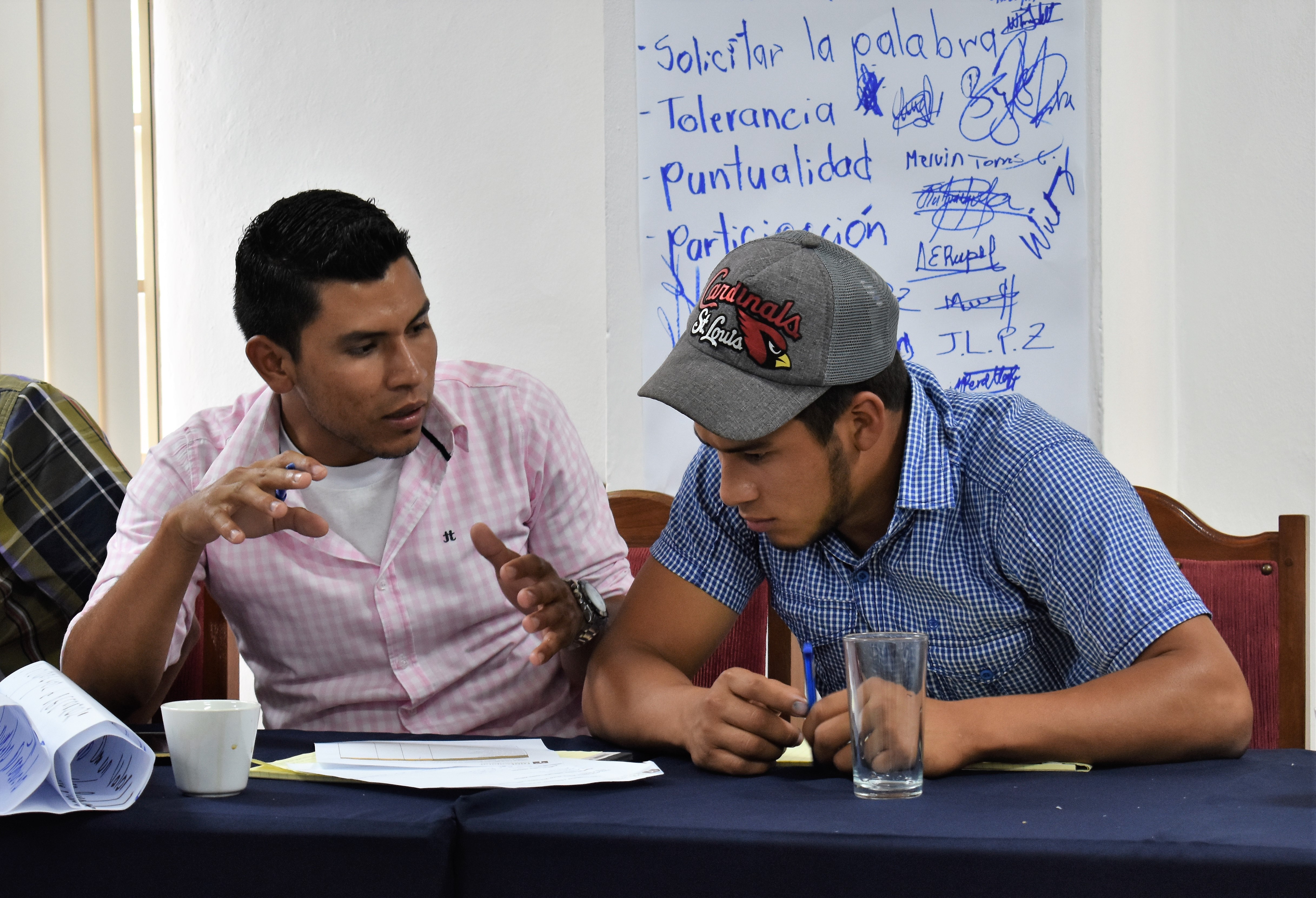El Polo producer-member Byron Ismael Lira Sandoval (left) discusses an idea for a project with another member of the youth group. 