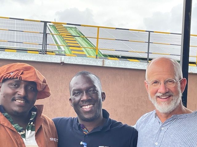 From left: Superfine Africa Nuts’ Solar Lead, Benson Matheri, with Peter Onguka, Root Capital’s Head of Lending, Africa, and Willy Foote in front of the solar panels at Superfine Africa Nuts’ cracking facility. Photo credit: Root Capital