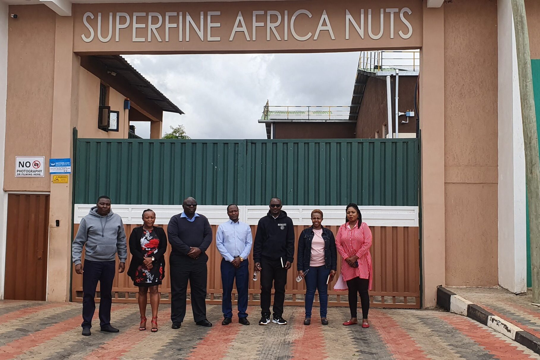 Superfine Africa Nuts employees at the entrance to the cracking facility. Photo credit: Root Capital