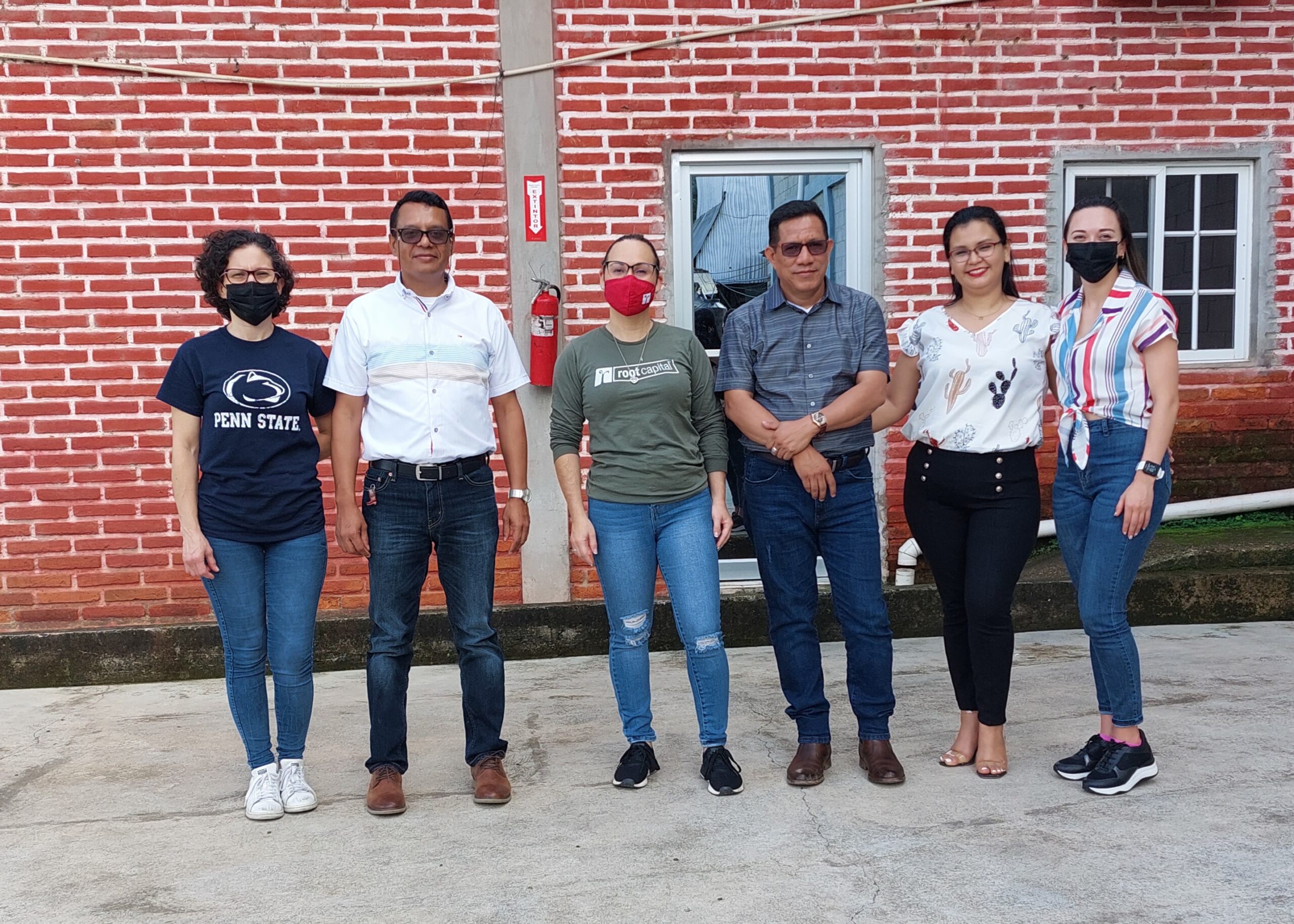 Employees at Cocaol, a Honduran coffee cooperative and Root Capital client since 2008, alongside Root Capital Senior Loan Officer Sharon Serrano and Root Capital Junior Loan Officer Roxan Piedra. Photo credit: Root Capital.