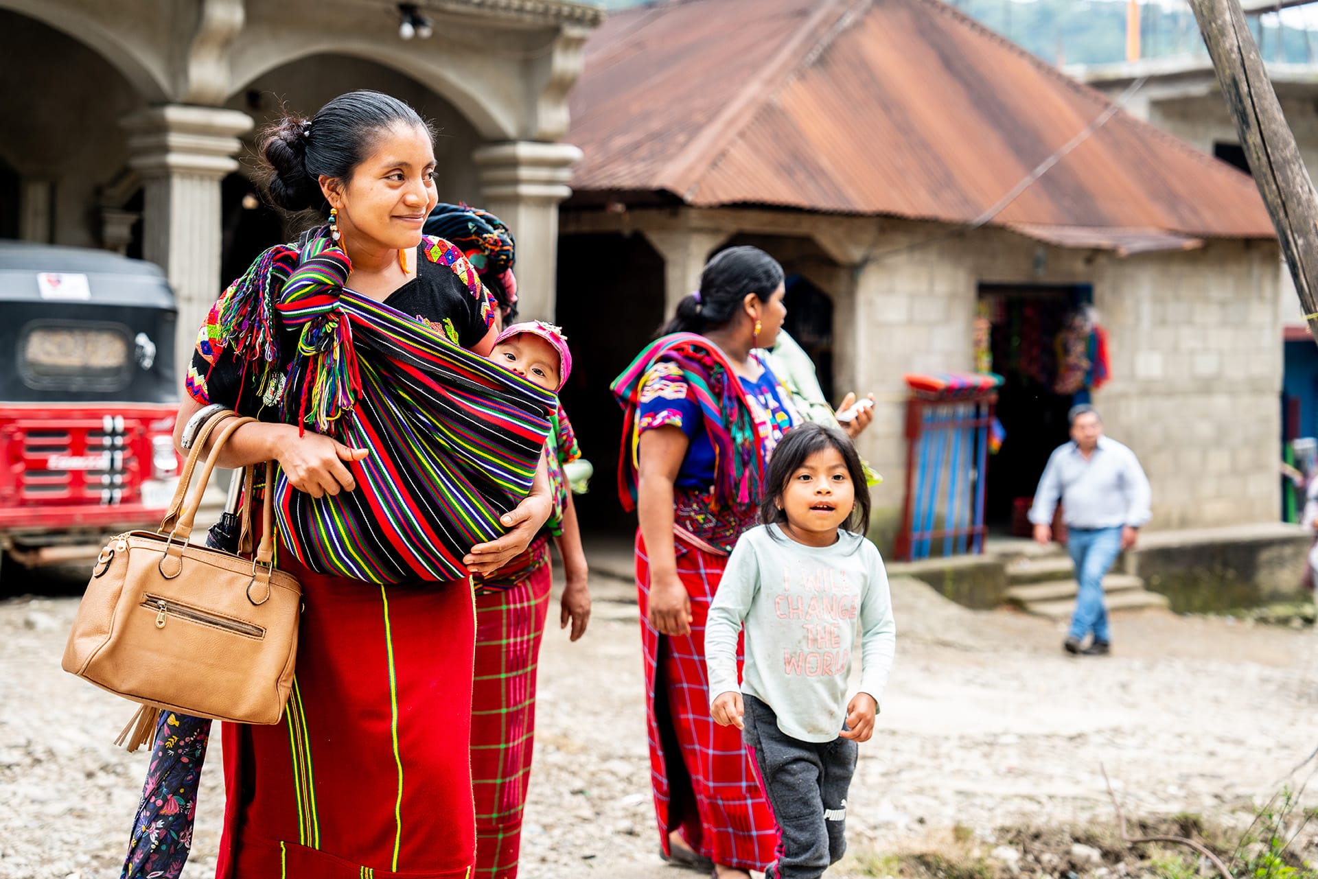 A producer and her children walk around their community in Guatemala. 